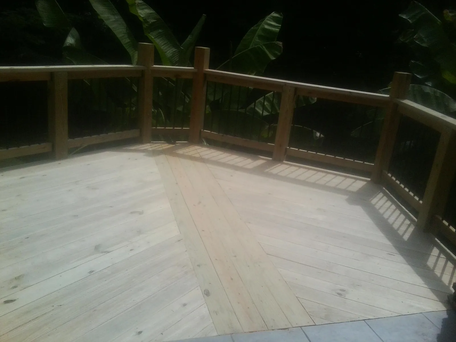 New wood deck and railing built off the back of a home in Estes Park